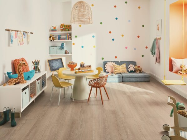 A room with a table and chairs, a chair, and a bookshelf.