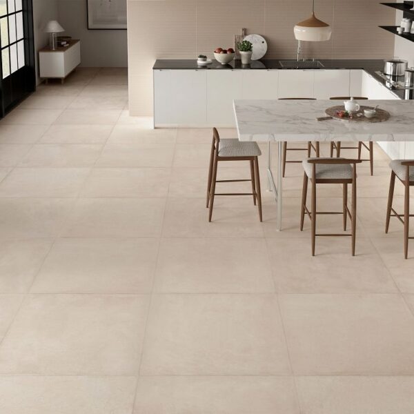 A kitchen with white walls and floors, and a table.