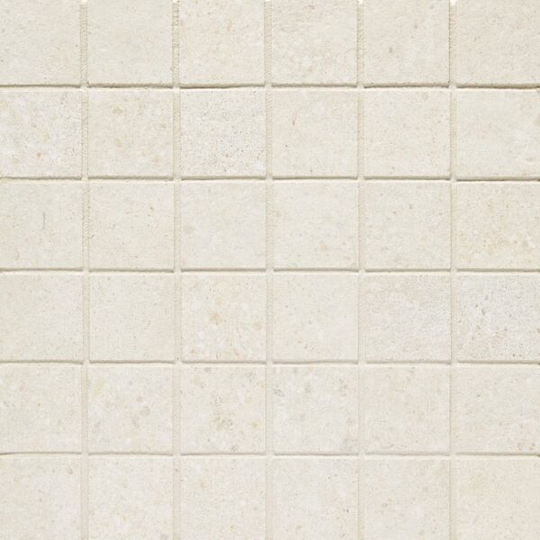A white tile wall with some small squares