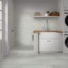 A white room with a sink and washer in it