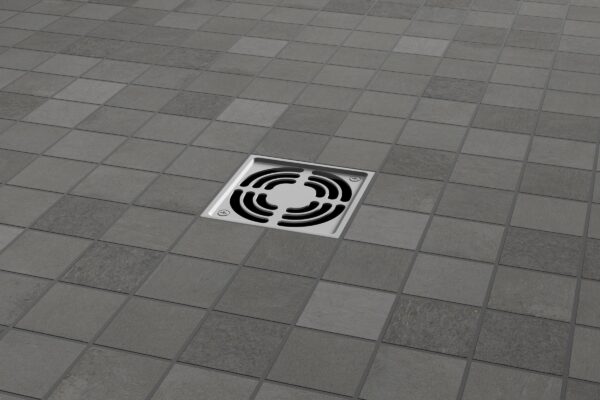 A floor drain with a tile pattern on the ground.