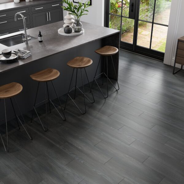 A kitchen with wooden floors and black cabinets